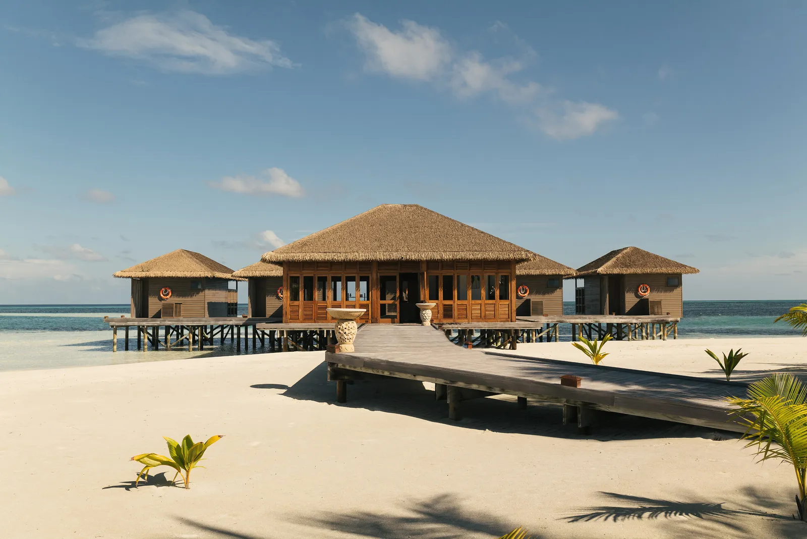 The spa: thatched pavilions on stilts, reached by a wooden walkway from the beach.