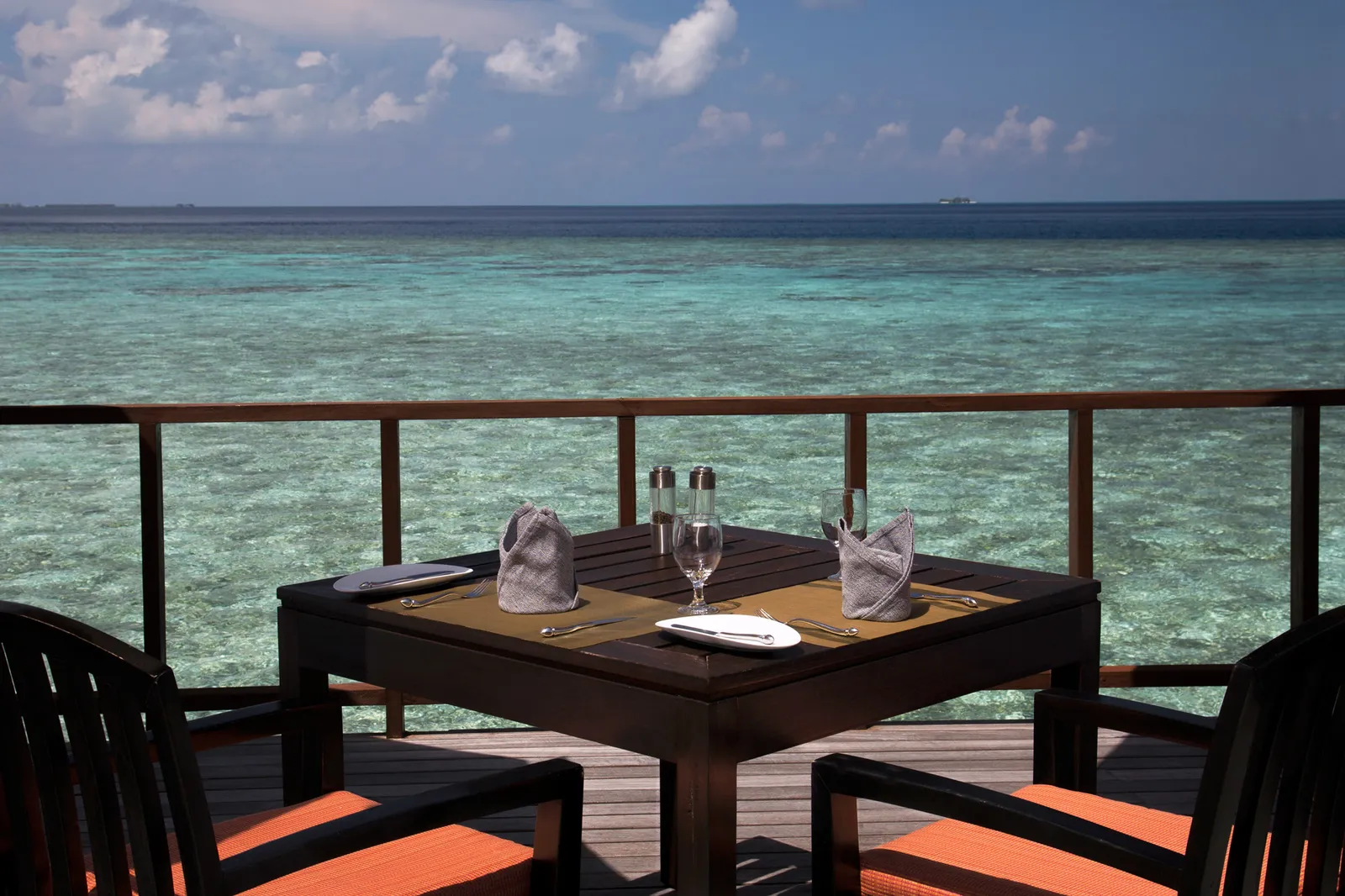A table for 2 on Stars’ deck, laid above the clear lagoon.