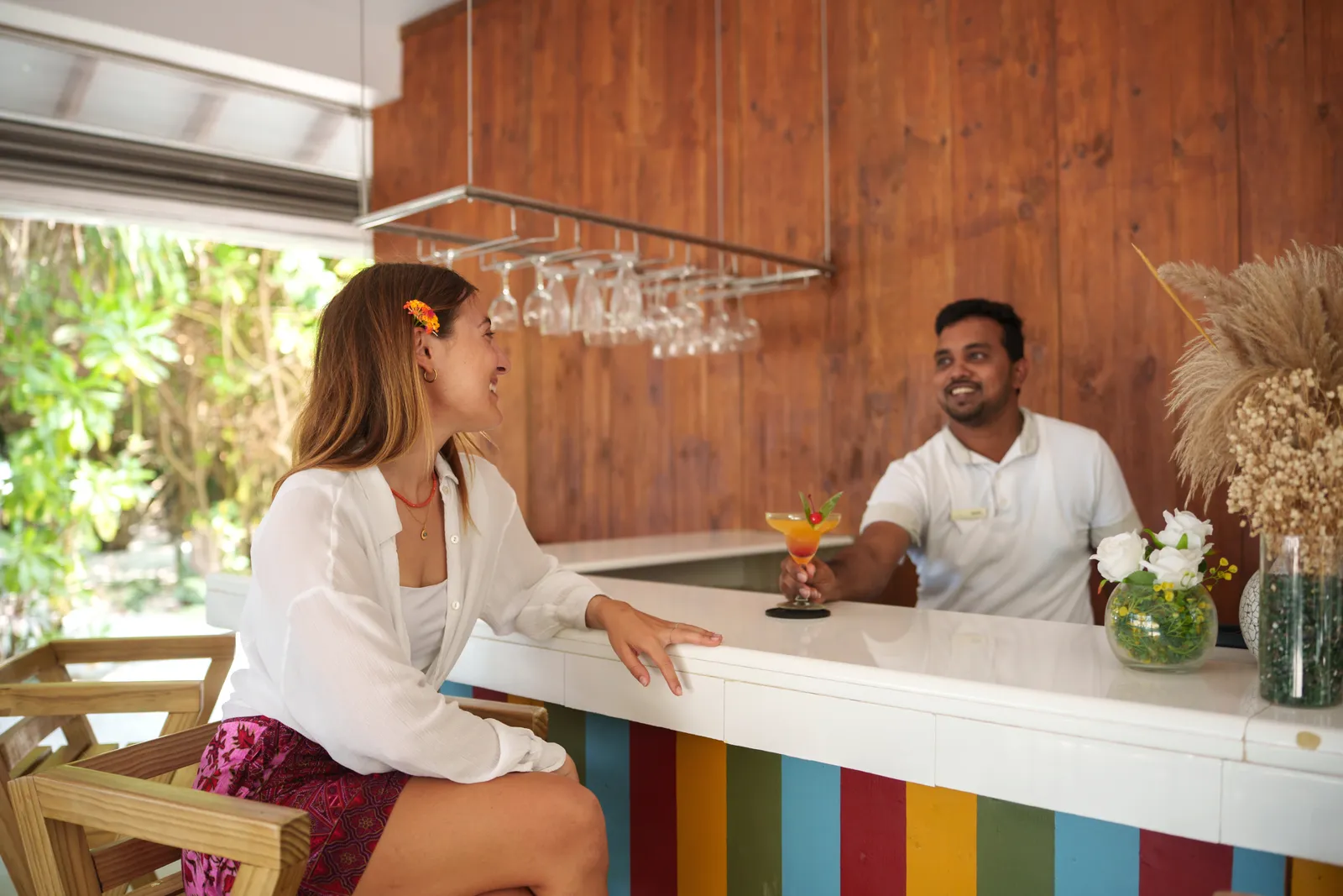 The Kurum-Bar counter, a guest and the barman with a cocktail
