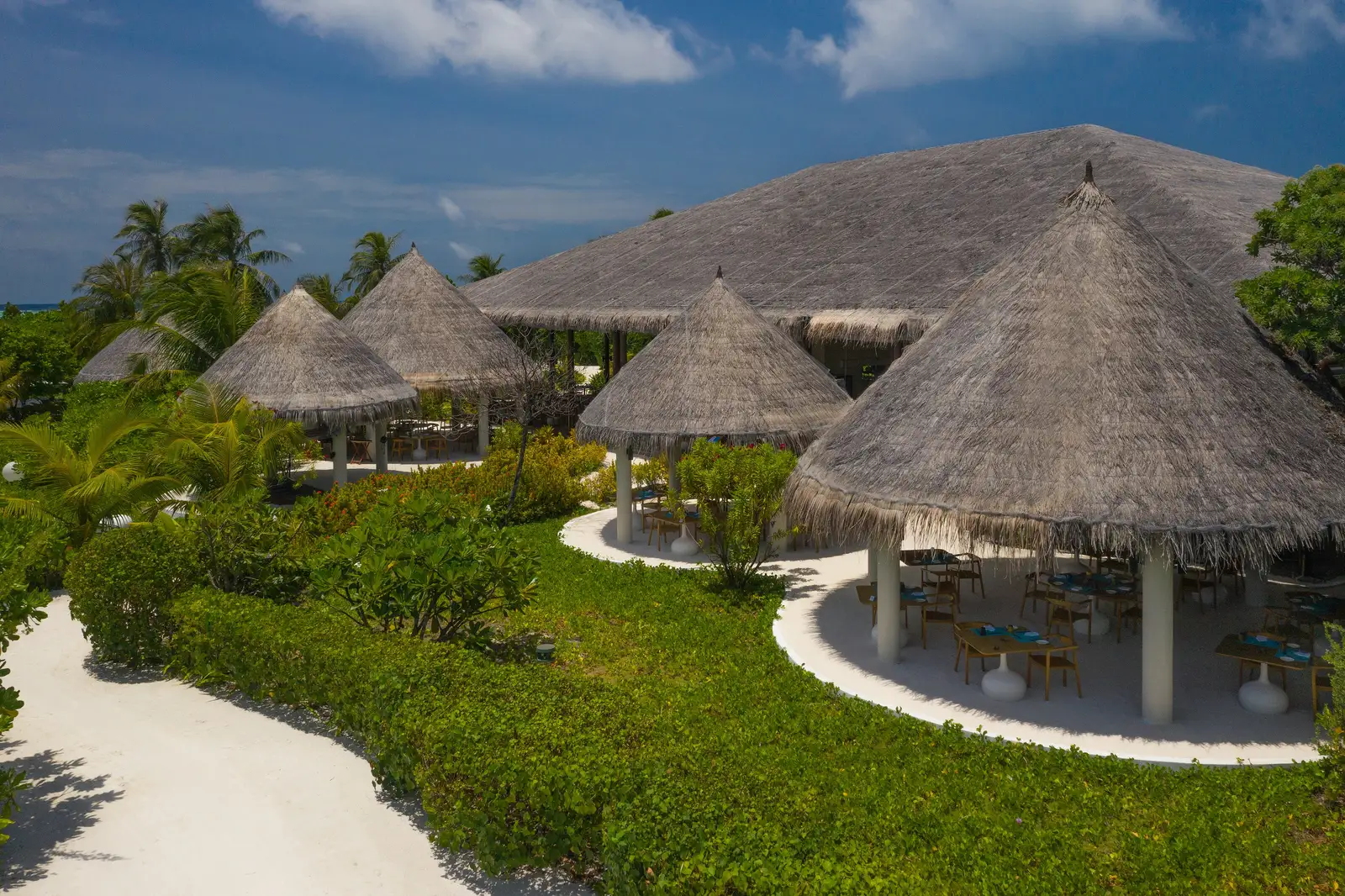 The Octopus’s thatched roofs between the lawn and the sand paths