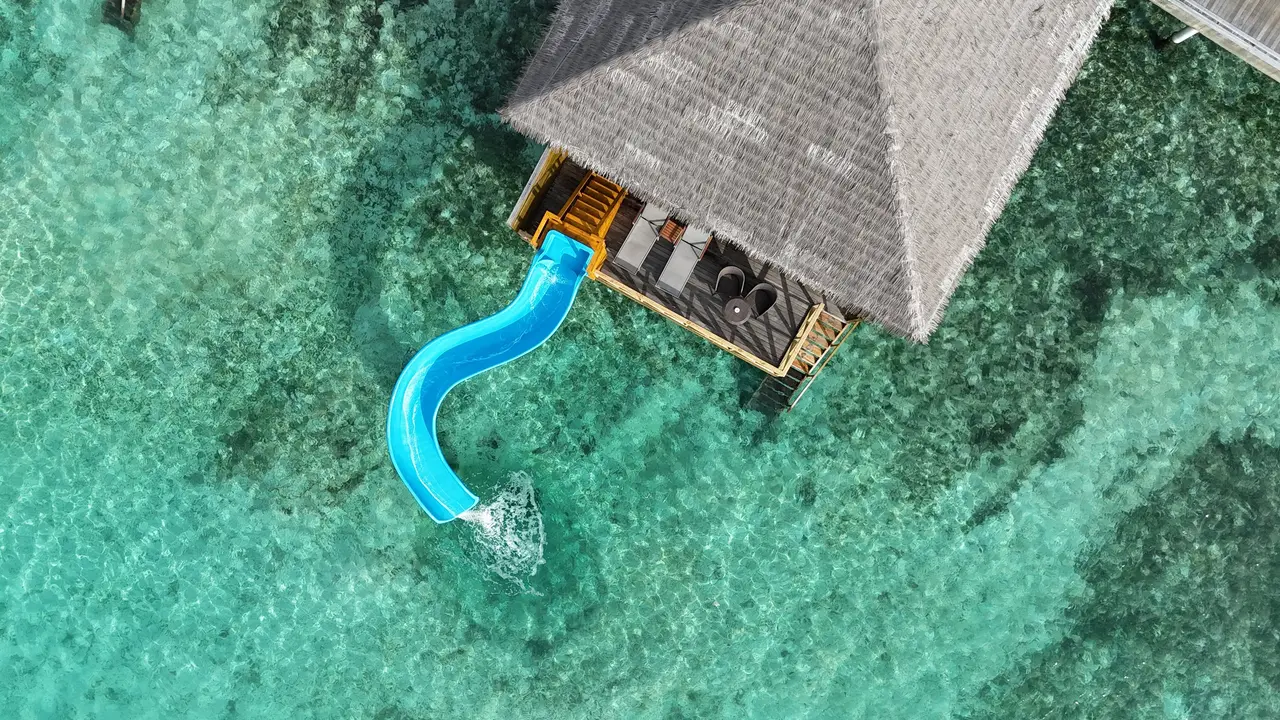 A Lagoon Suite with Slide from above, the blue slide ending in the lagoon