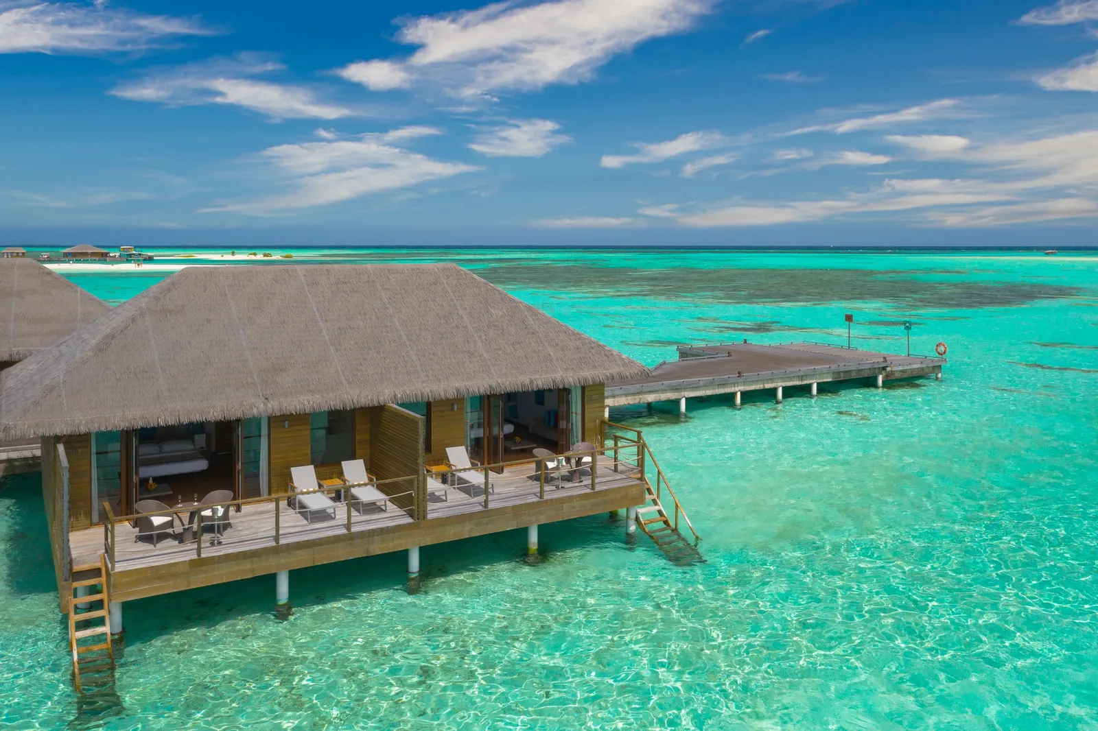 A Lagoon Villa over the water, the deck with loungers and the ladder into the lagoon