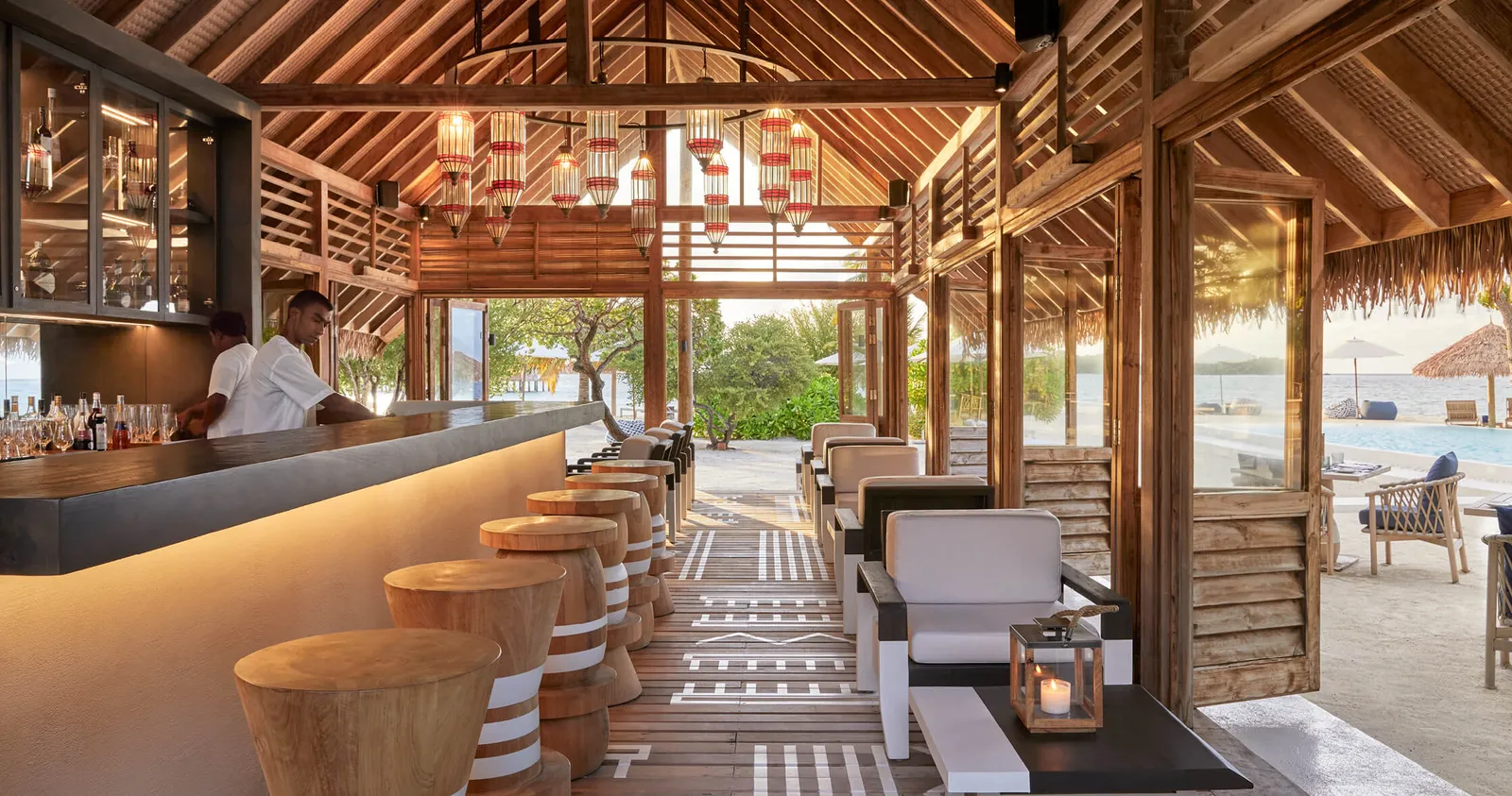The bar counter under its timber roof, open to the beach
