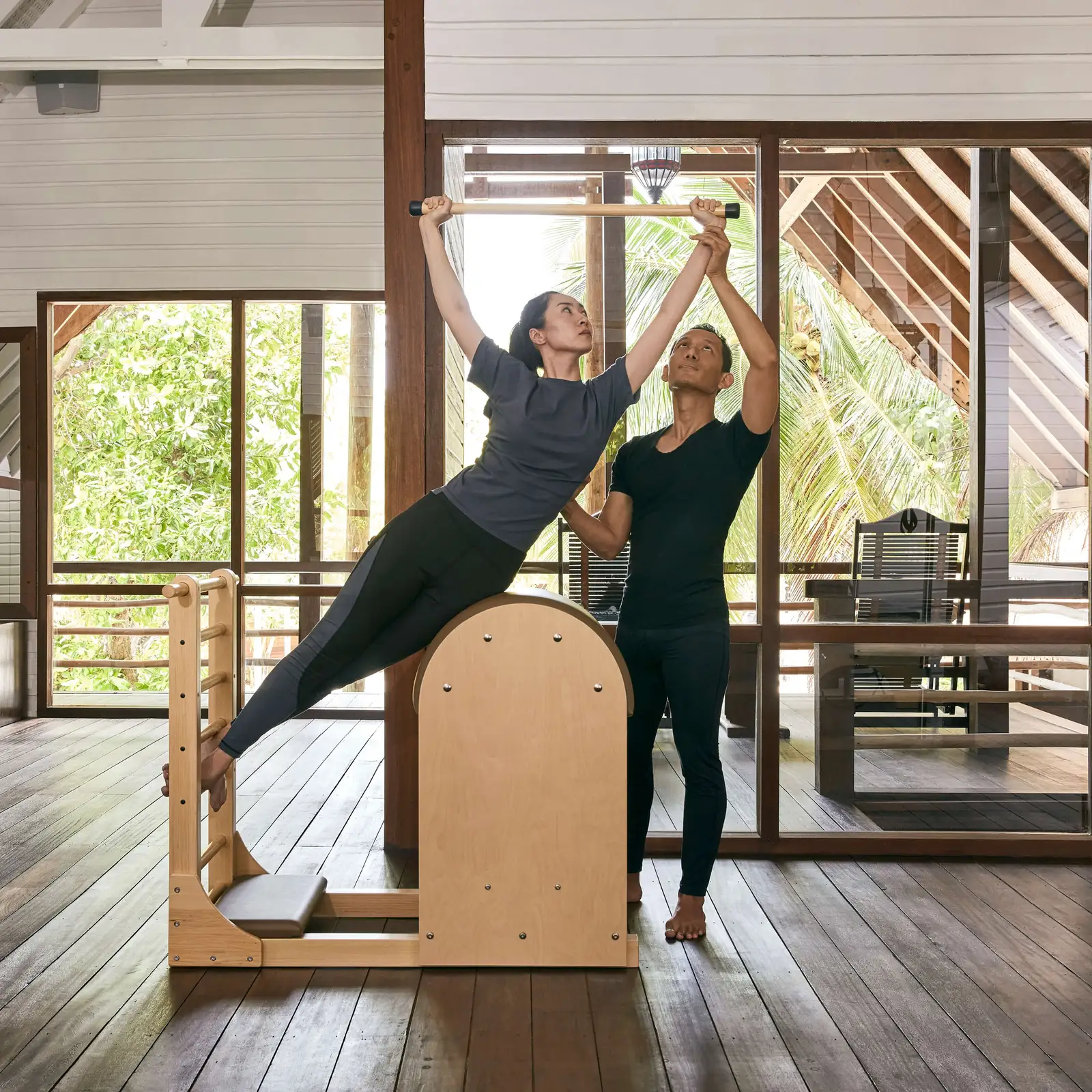 A Pilates session on the ladder barrel with the instructor, in the timber studio