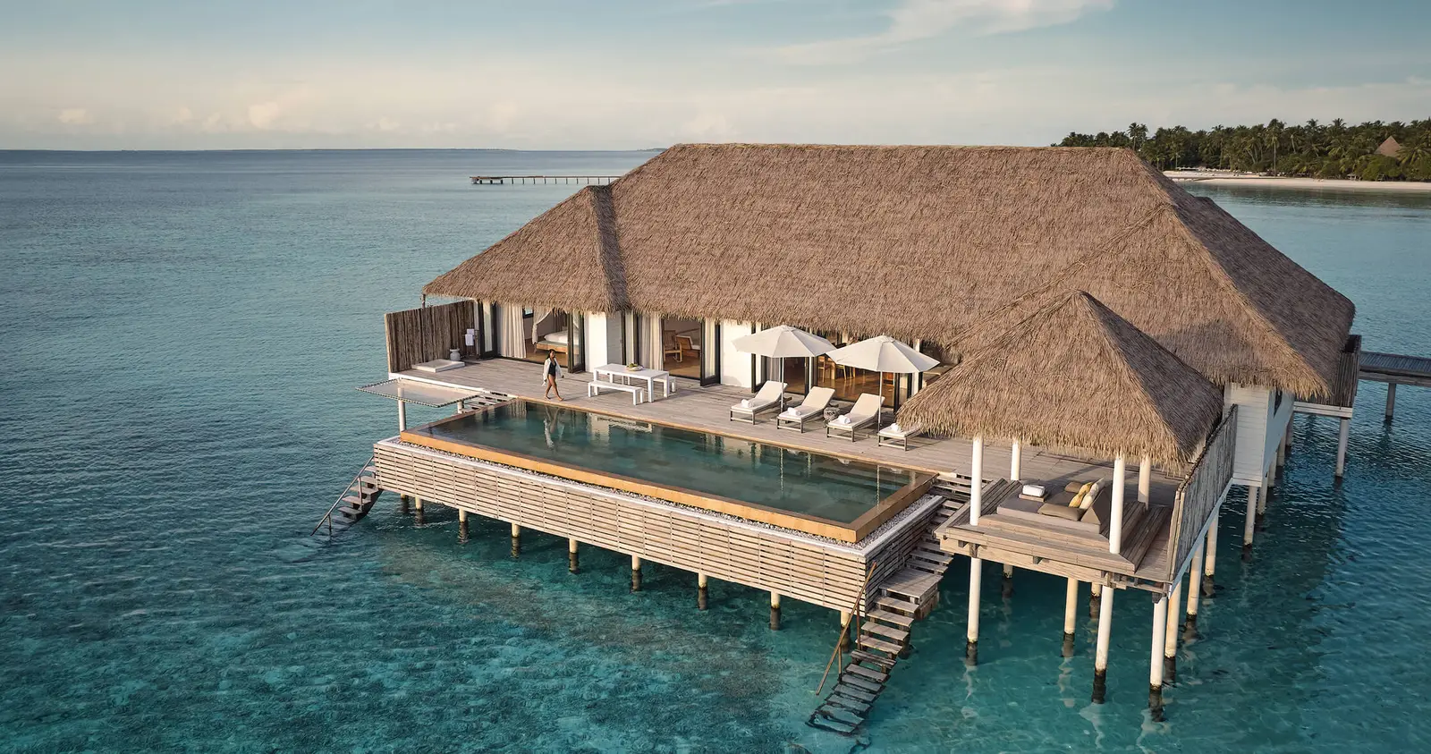 The Maalifushi Water Villa from above, at the end of its own jetty, with an infinity pool over the lagoon.