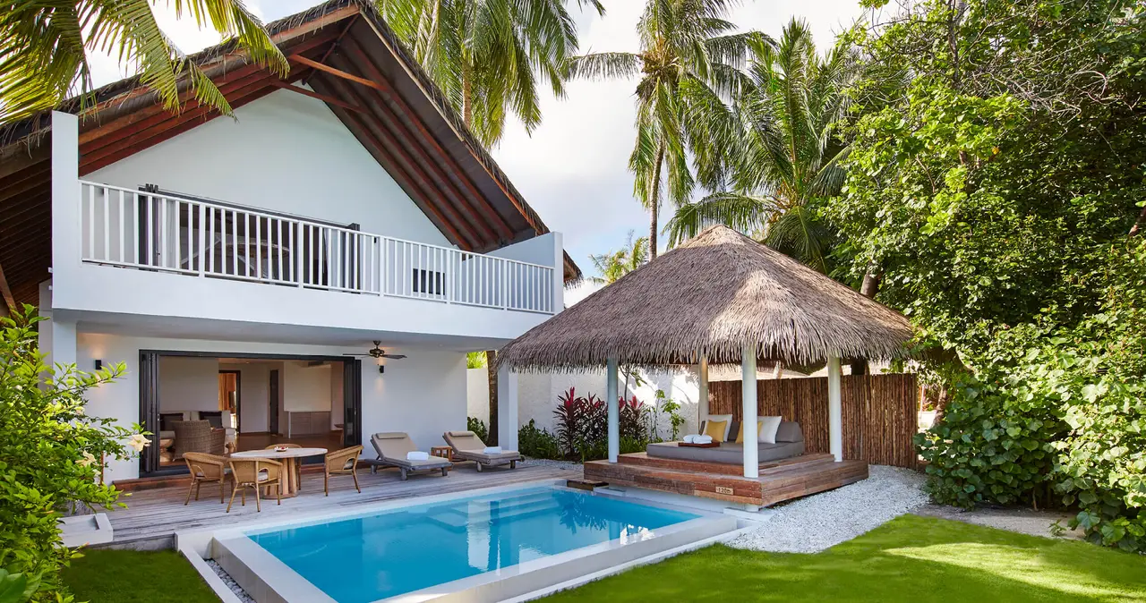 The 2-storey Two-Bedroom Beach House, with its pool on the lawn and a thatched pavilion.