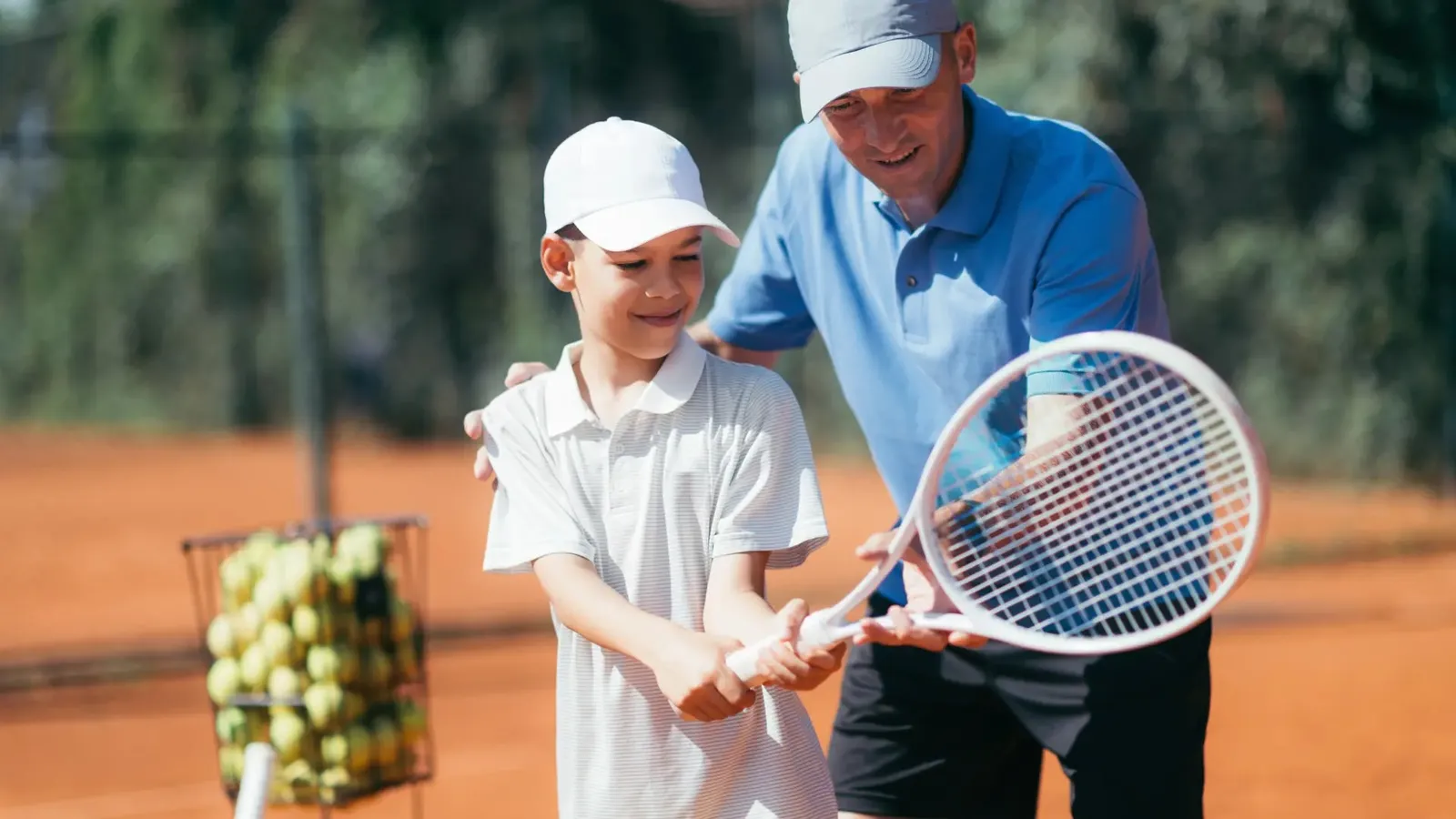 A boy learning tennis with the coach