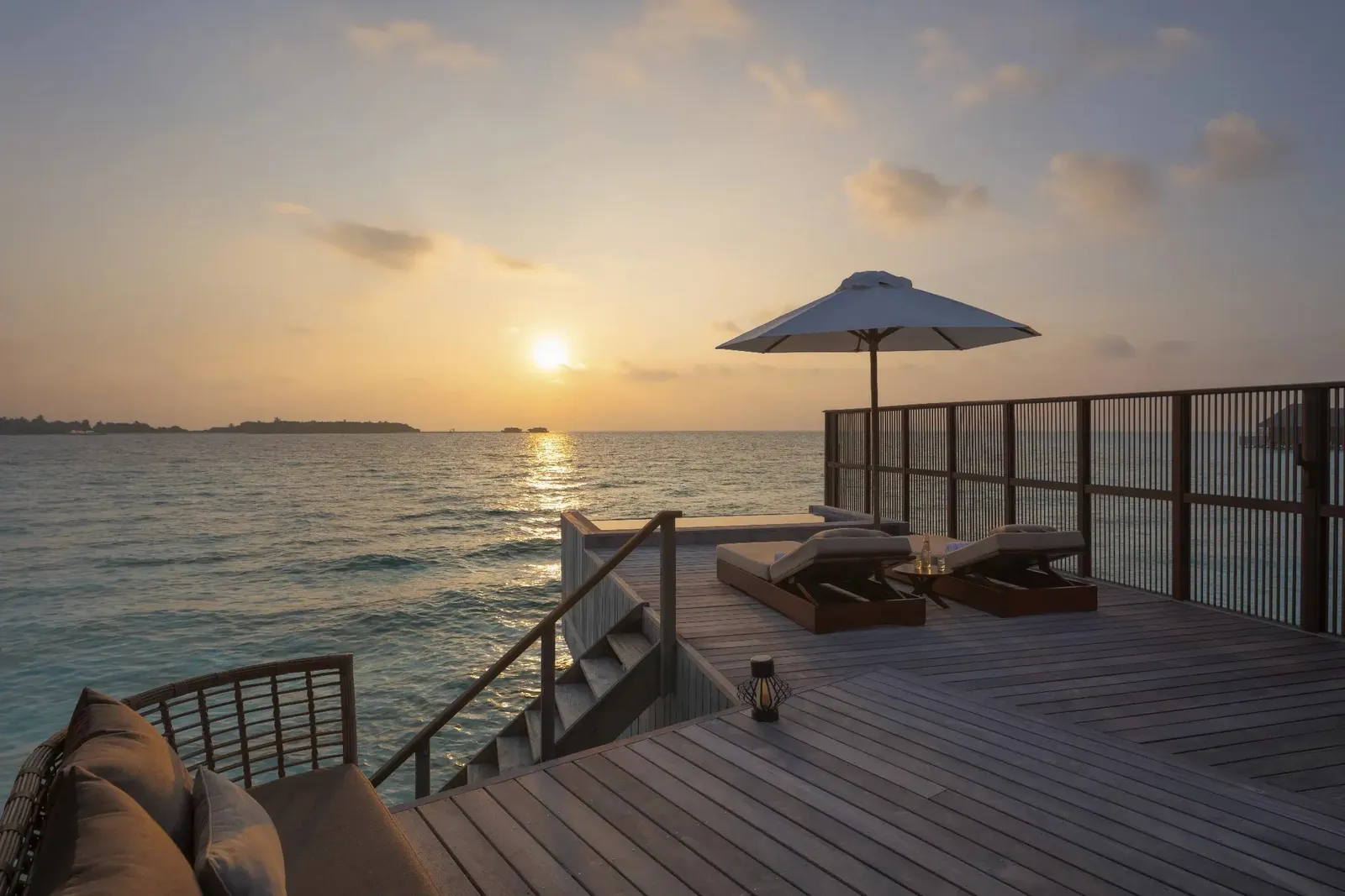 A 2 Bedroom Grand Water Villa with Pool’s deck at sunset