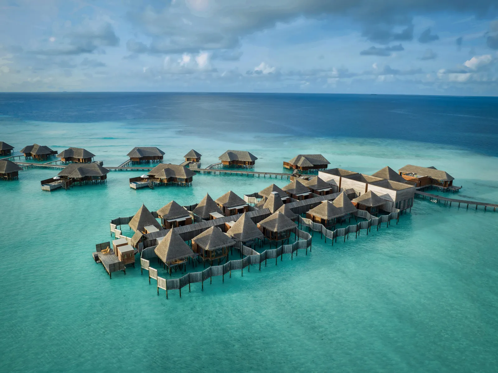 Water villas from the air, over the turquoise lagoon