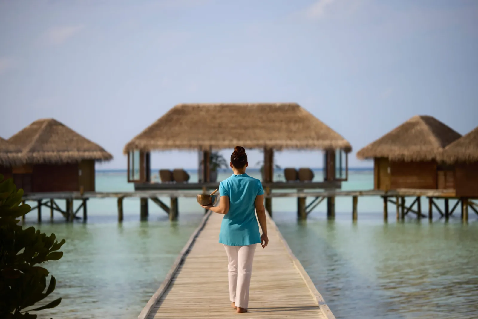 A therapist on the spa’s jetty, its thatched pavilions