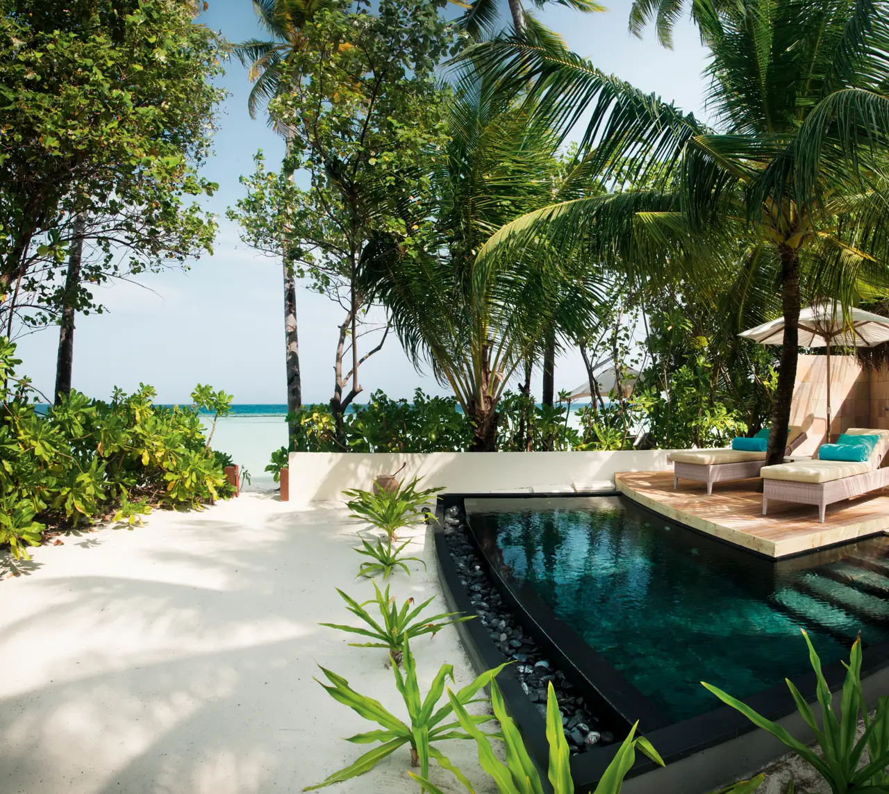 The Family Beach Villa’s pool and garden.