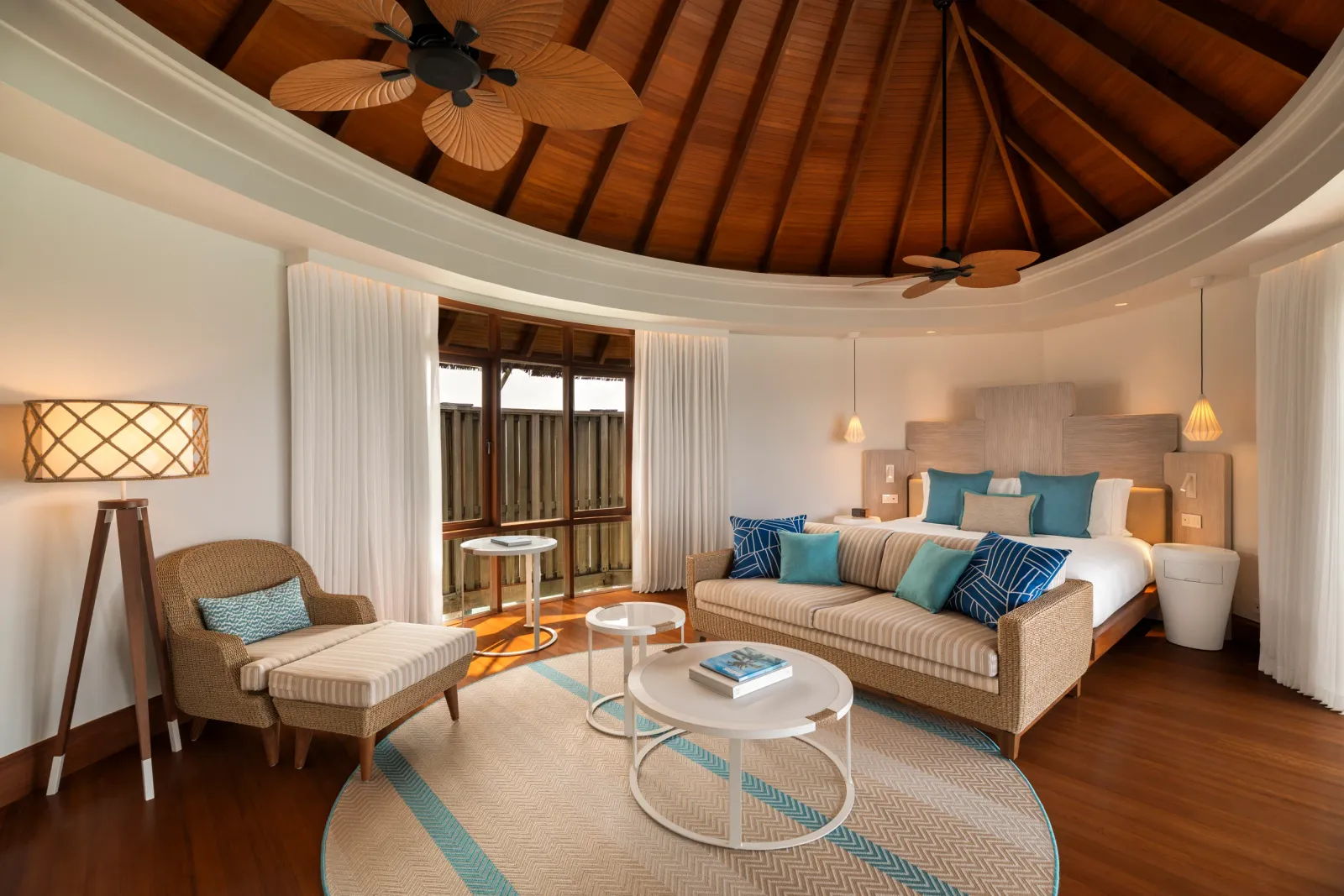 The Water Villa interior, with bed and sitting area.