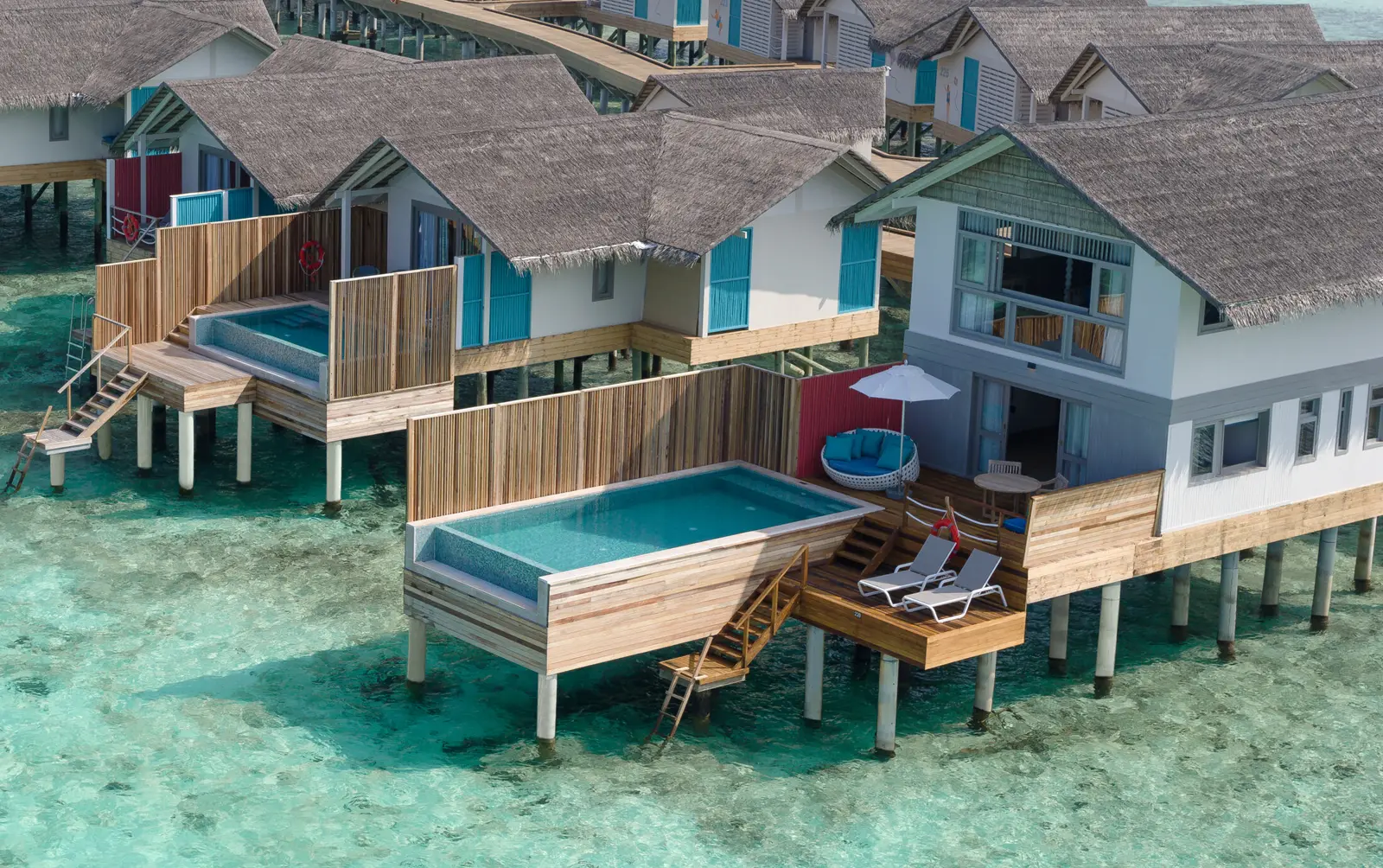 The 2-storey Duplex Lagoon Pool Villas over the water, each with a pool on its deck and a ladder into the lagoon.