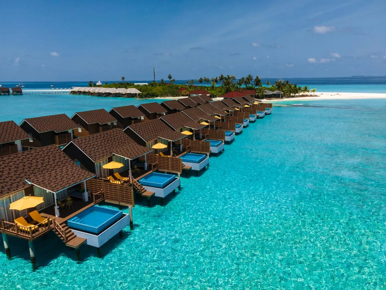 The row of Pool Water Villas, each with its plunge pool on the deck, and the island behind.