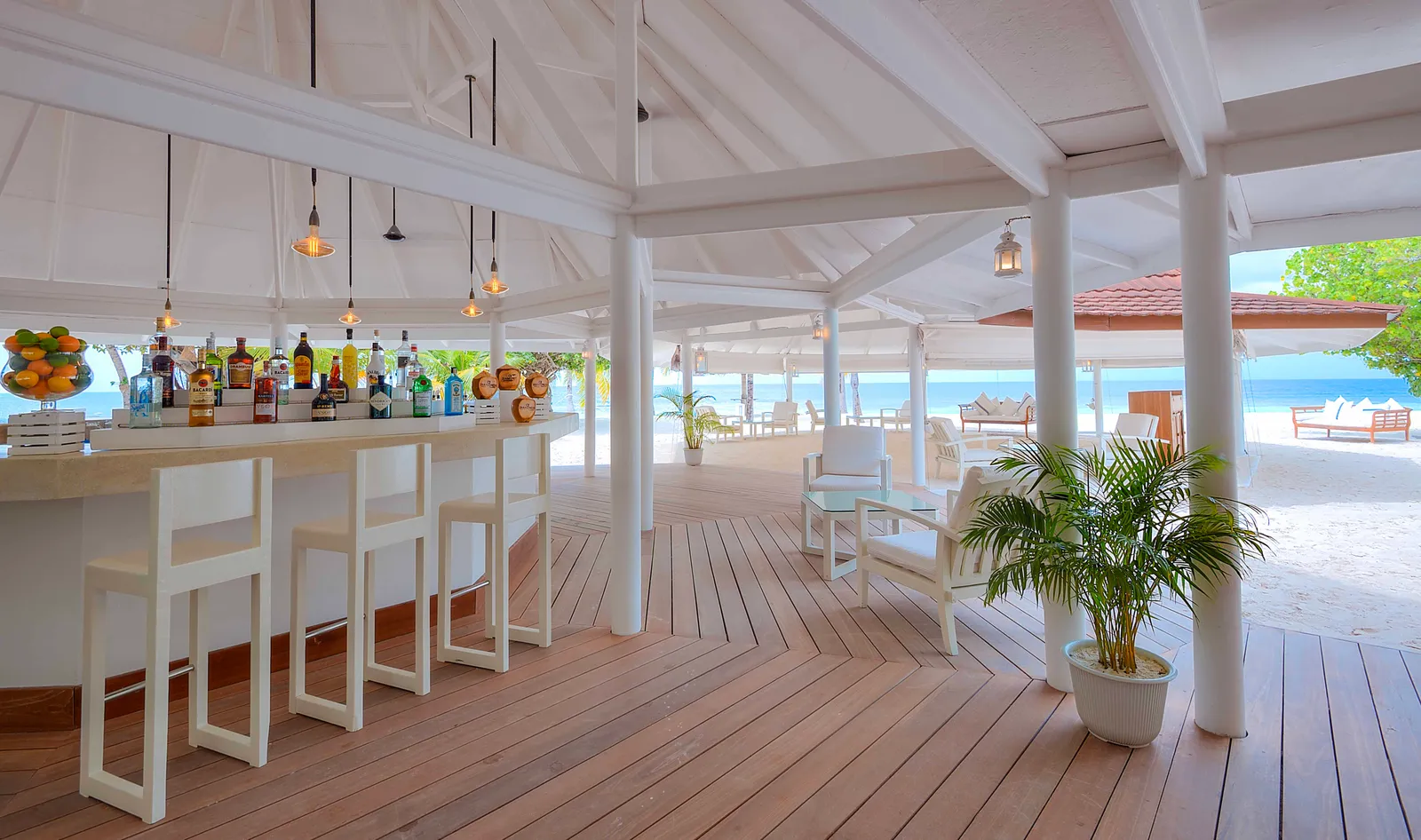 Boli Beach Bar, with its white counter, stools and wooden deck open to the beach.