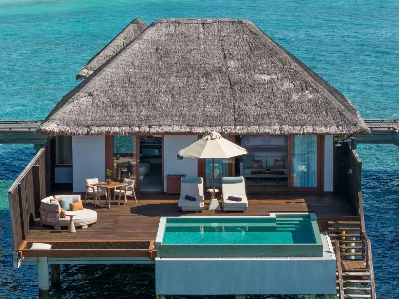 An Overwater Pool Villa from above, with its deck, pool and the ladder down to the reef.