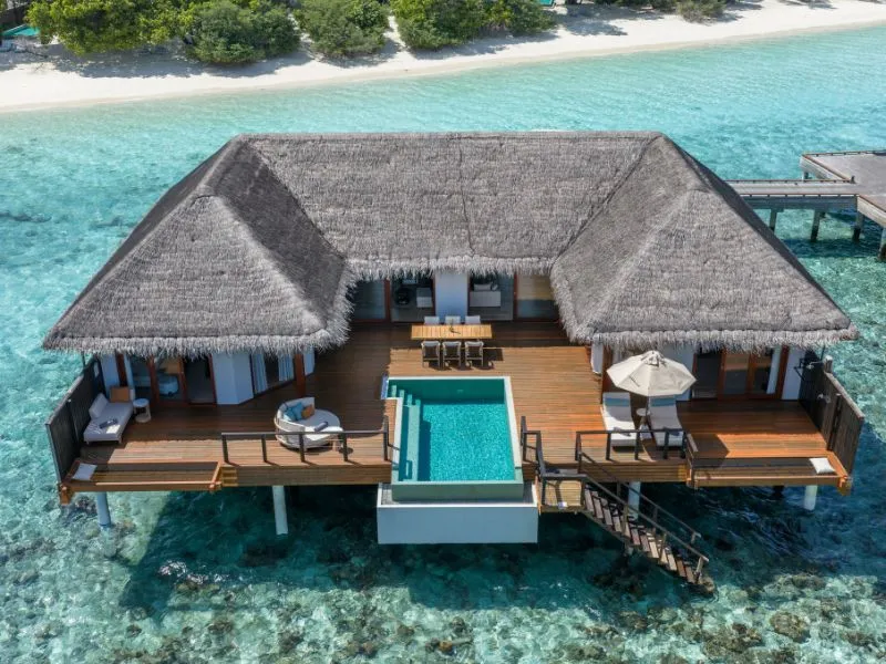 The Two Bedrooms Overwater Pool Pavilion from above, on stilts over the lagoon, its pool on the deck.
