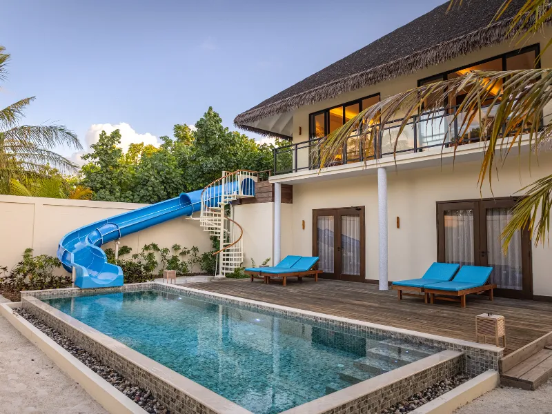 The Two-Bedroom Garden Residence: the 2-storey house, its private pool and the blue slide that runs down into it.