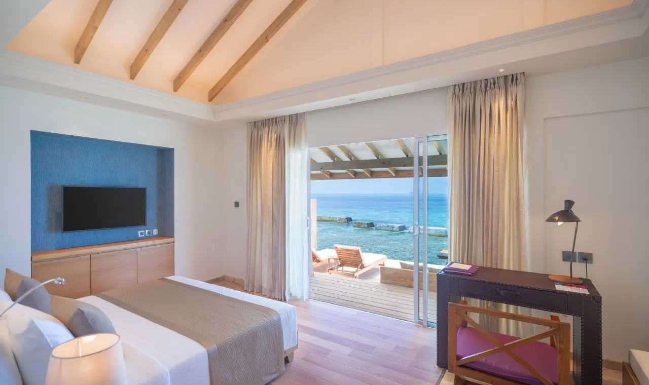 A Superior Room, the bed and the terrace open to the sea