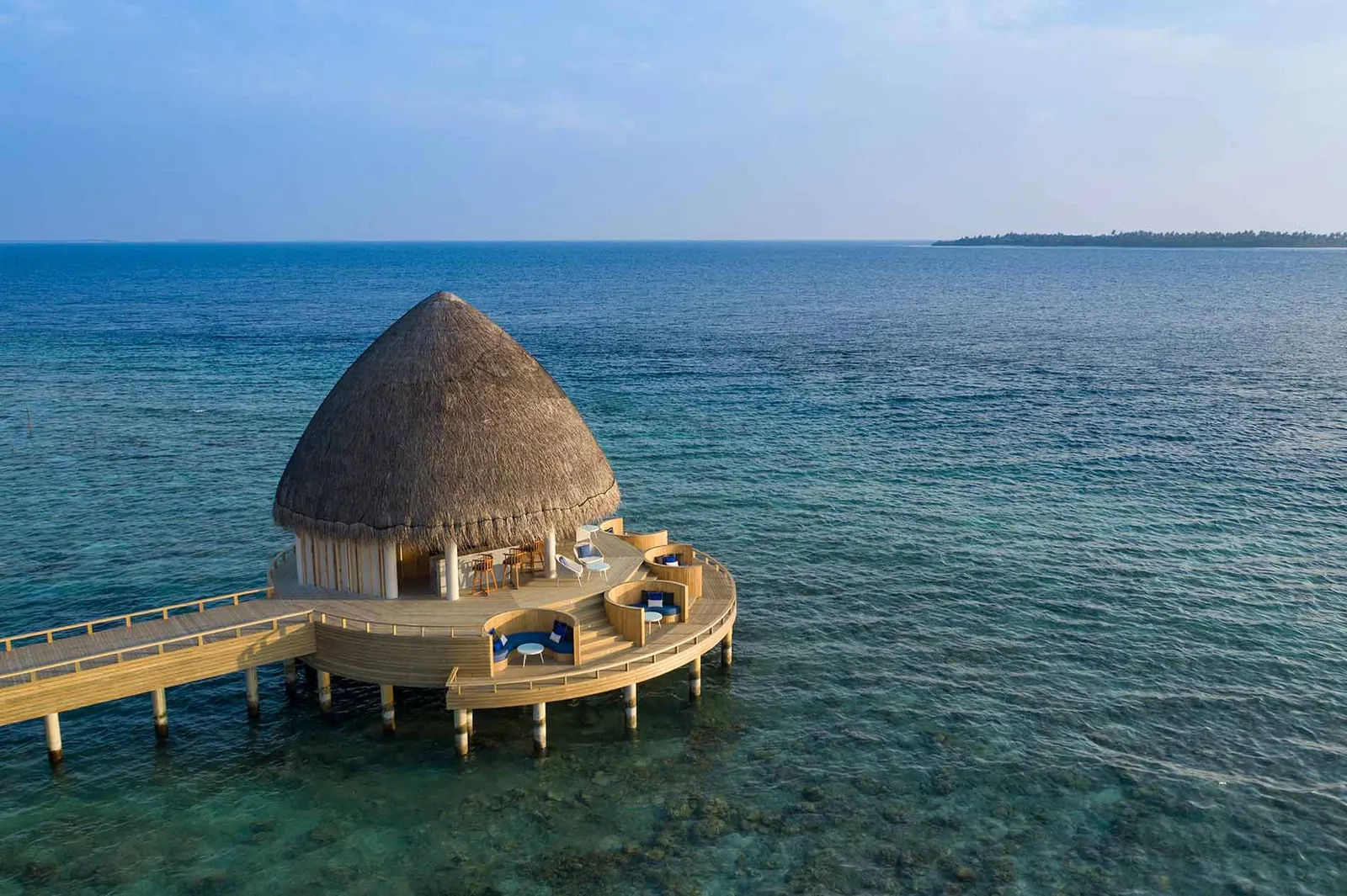 Eclipse Bar from above, a round thatched pavilion on stilts in the open sea at the end of the jetty.