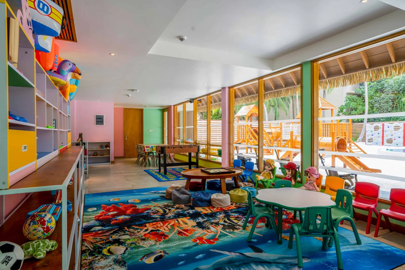 The Dolphin Kids Club’s playroom, with colourful shelves, little tables and a sea-themed rug.