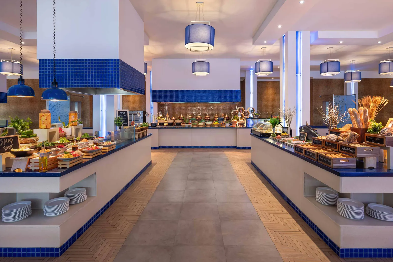 The Aqua buffet, its cooking stations under blue lamps and blue and white tiles.