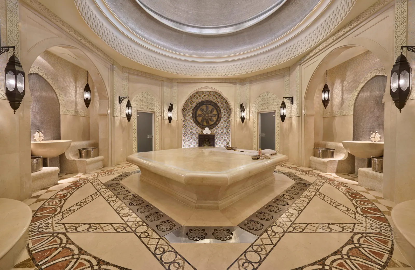 A hammam room under a decorated dome