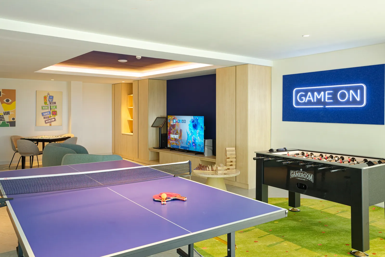 The games room, with a table-tennis table, table football and a television with a games console.