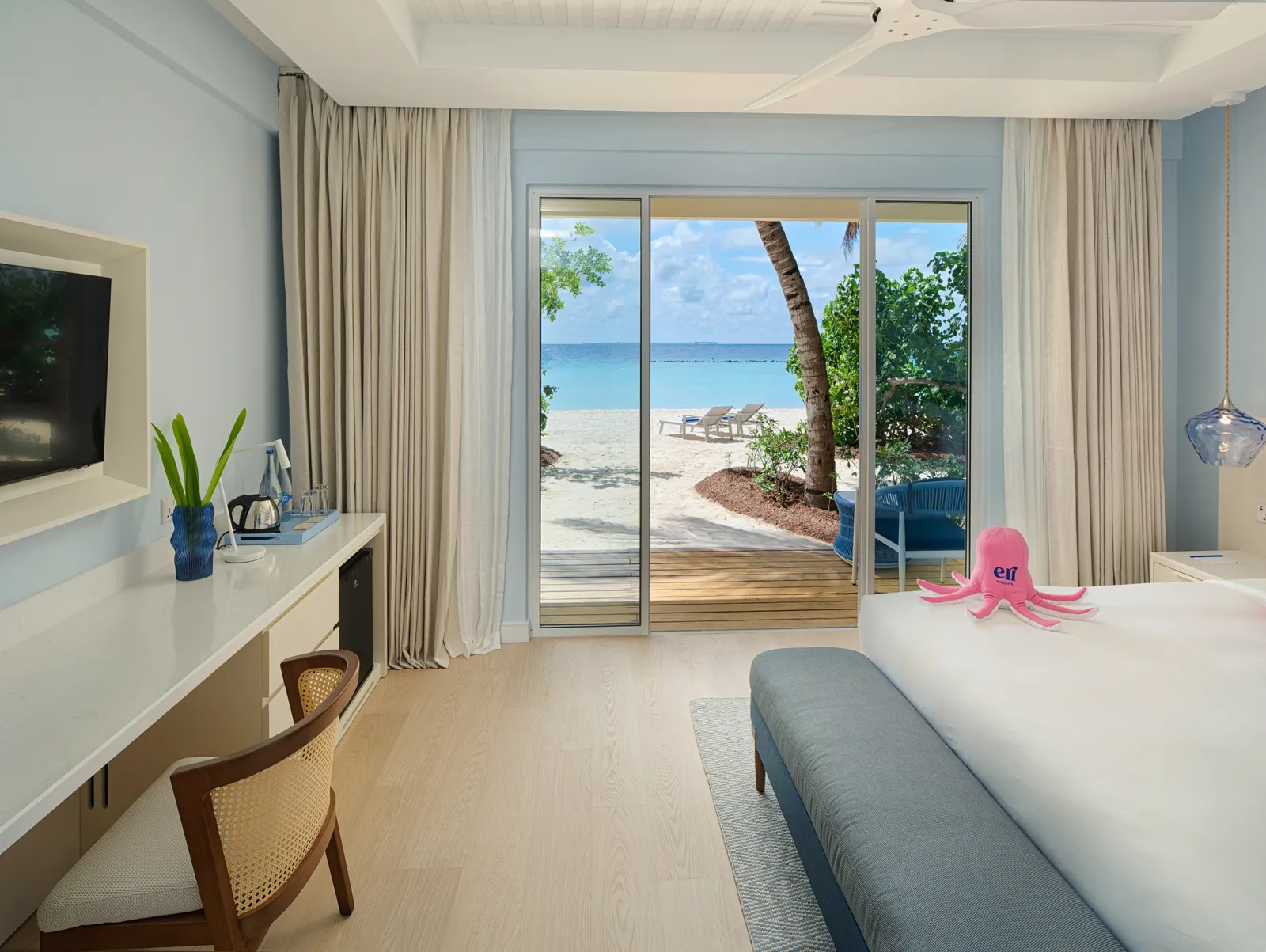 A ground-floor Beach Studio, with its king bed and the glass door onto the terrace and the beach.