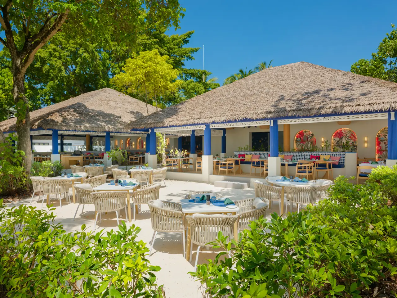 Soul Kitchen’s outdoor tables among the greenery, under the restaurant’s thatched roofs.