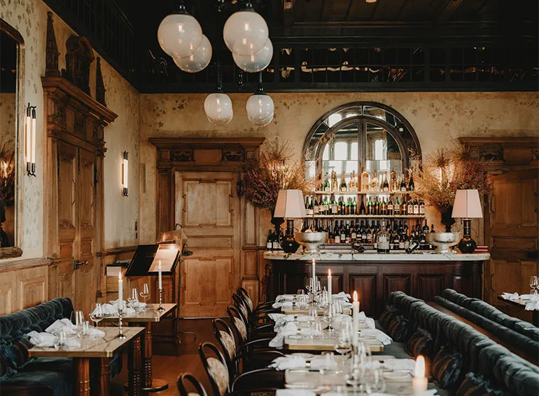 The Brasserie laid for service, with the bar and globe lamps