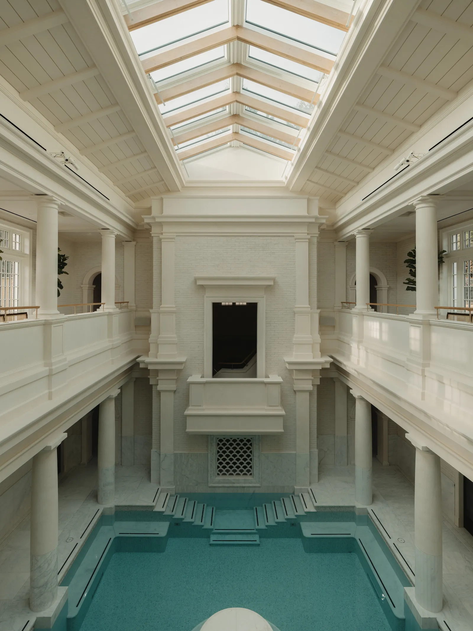 The Eynsham Baths tepidarium, its pool under the skylight between white columns
