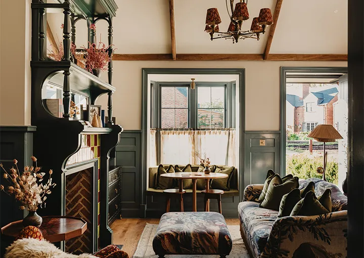 A Large Walled Garden Suite: the sitting room with a timber fireplace and a window on the garden