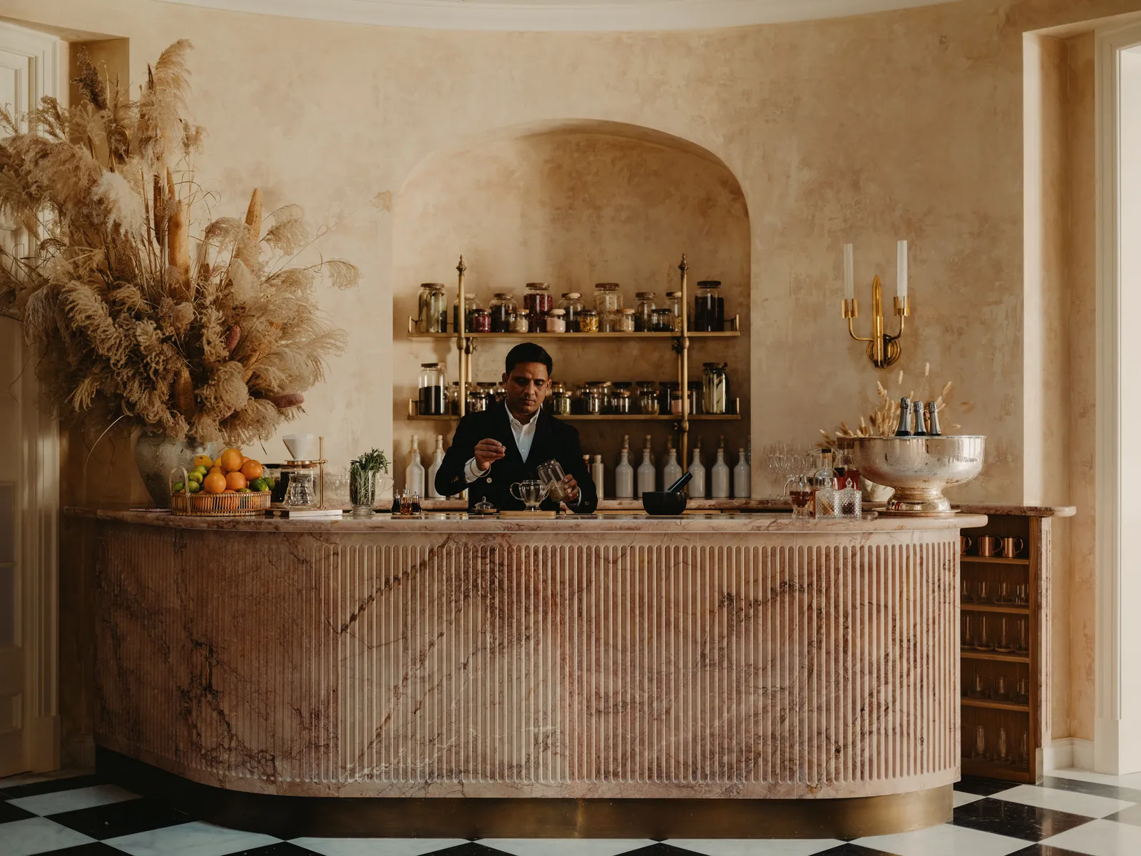 The Tea Lounge’s Breccia Medicea marble bar, with tea jars and dried flowers