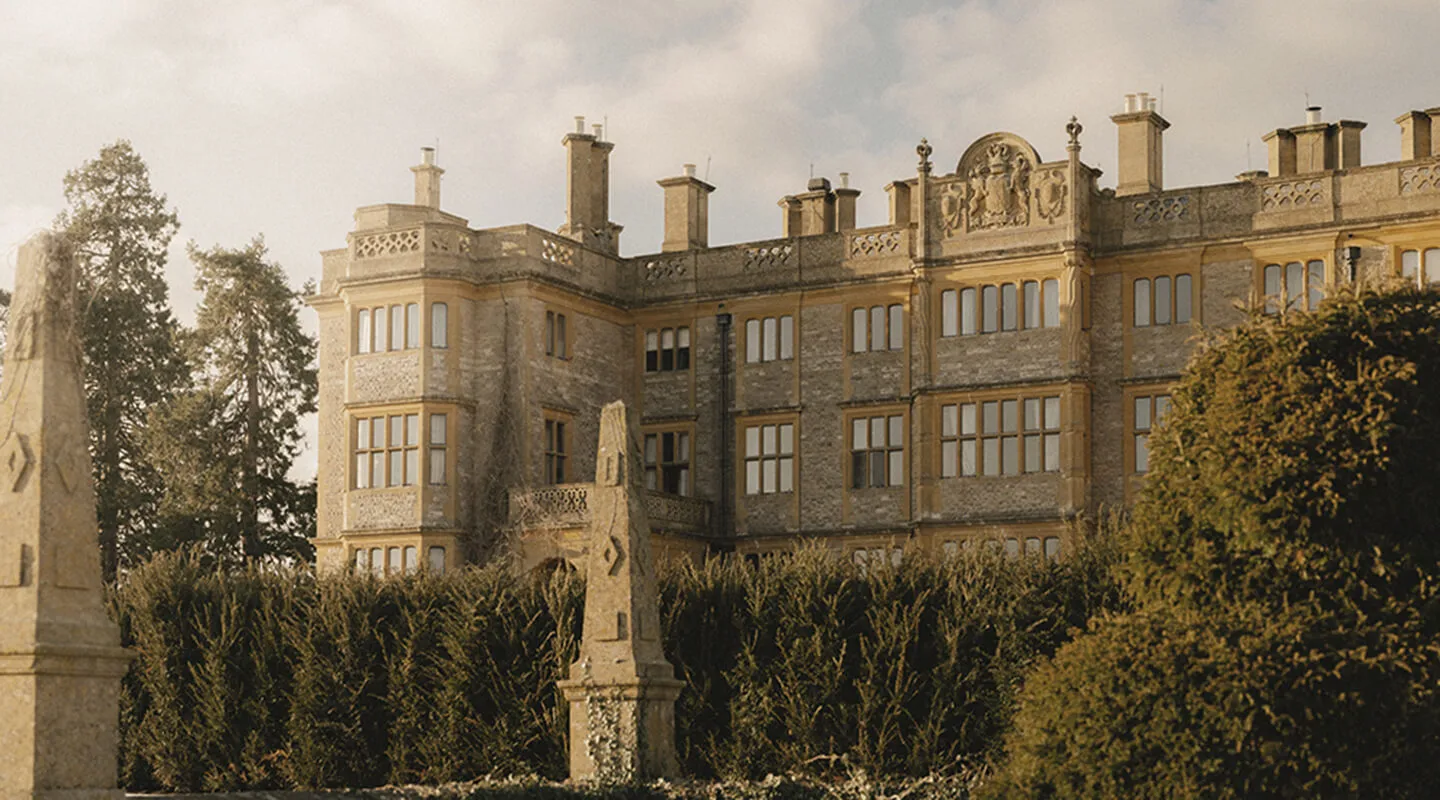 Estelle Manor’s neo-Jacobean stone front behind the garden hedges and obelisks