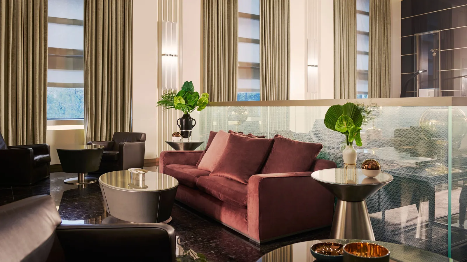 The Gallia Lounge, with a red sofa and armchairs by the tall windows