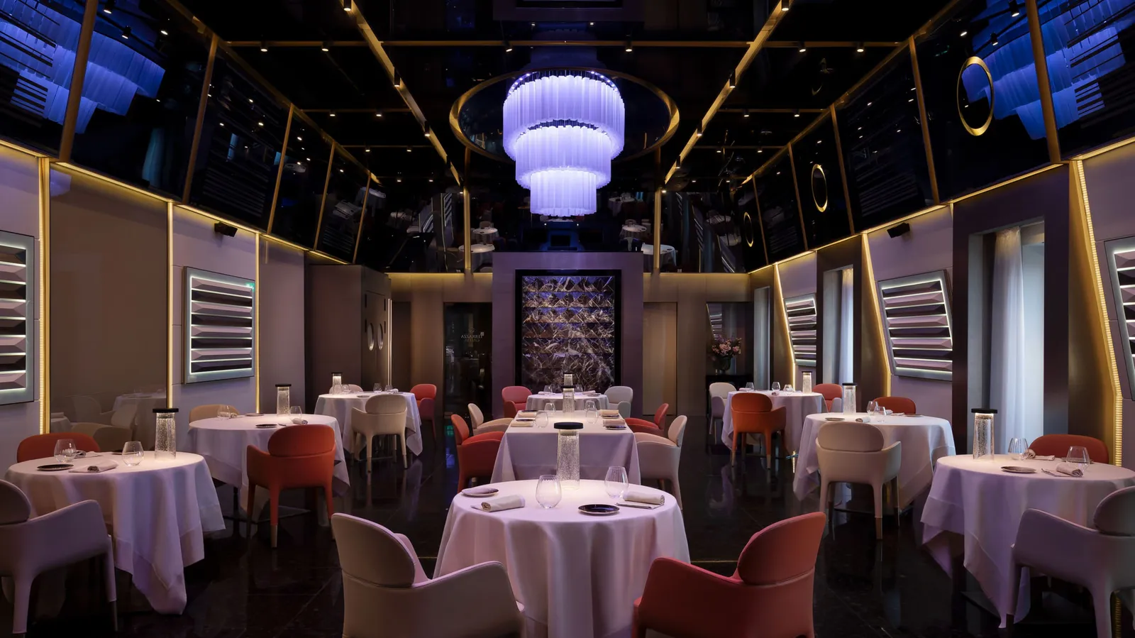 The Terrazza Gallia restaurant in the evening, tables laid under the lit ceiling