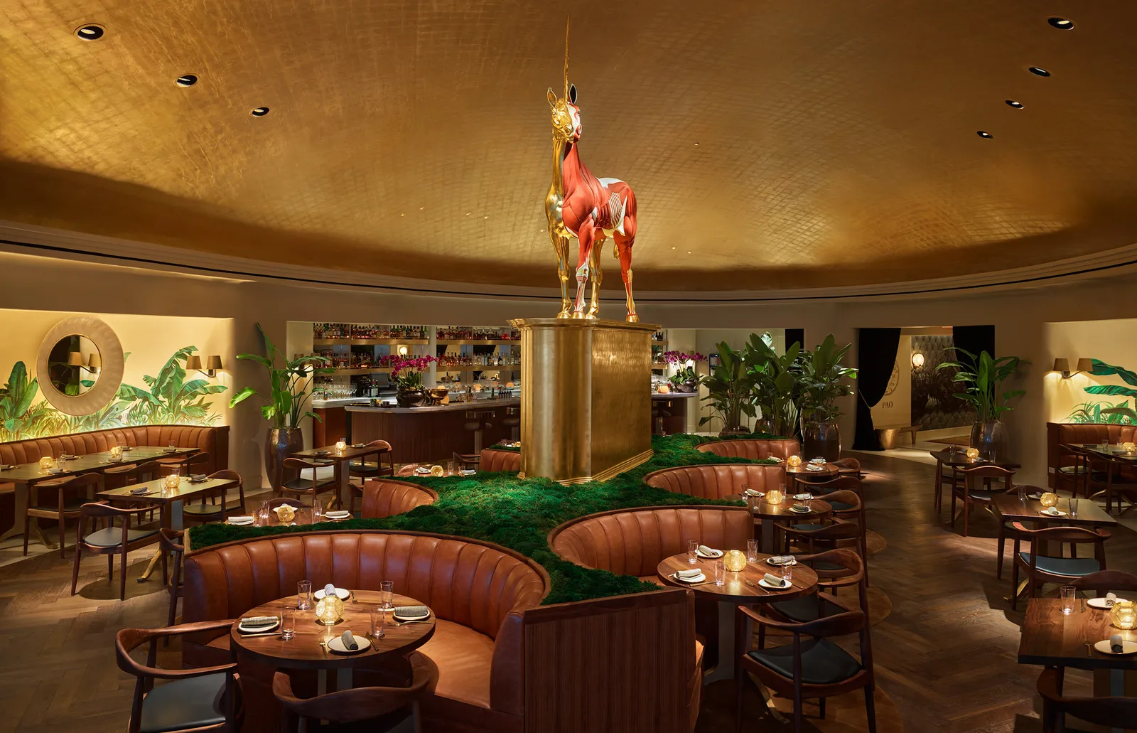Pao’s round dining room under its gold dome, with the unicorn sculpture on a plinth and leather banquettes.