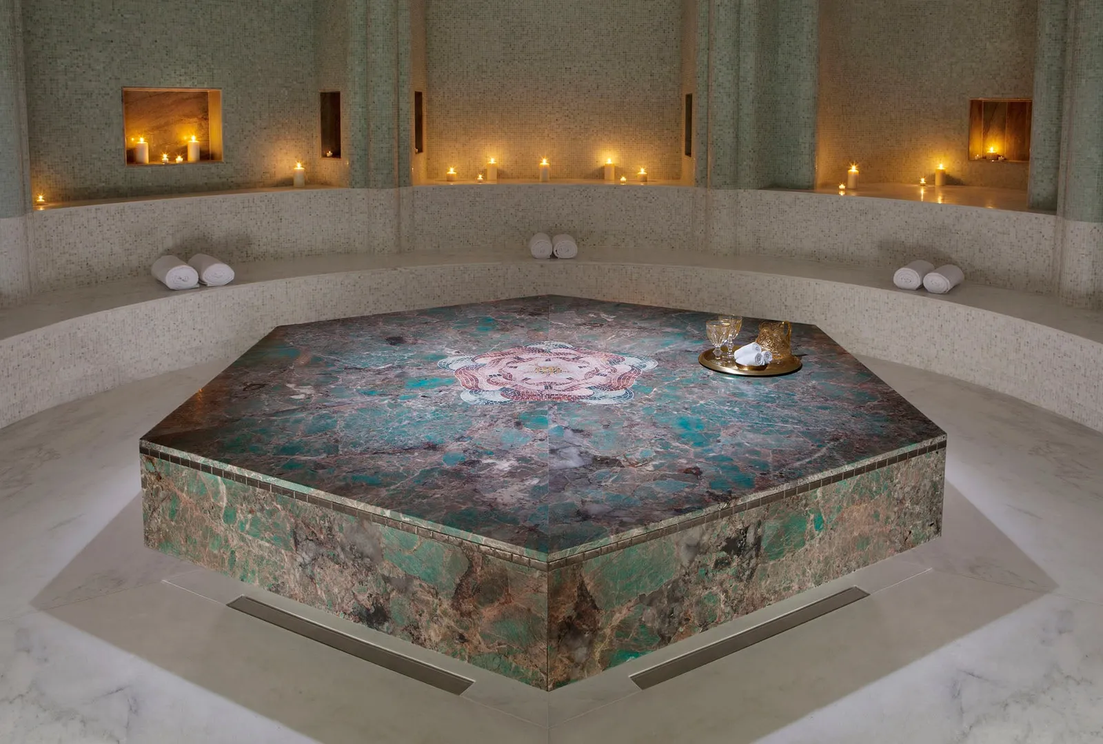 The spa’s hammam: a round room with candles in its niches and the heated hexagonal stone at the centre.