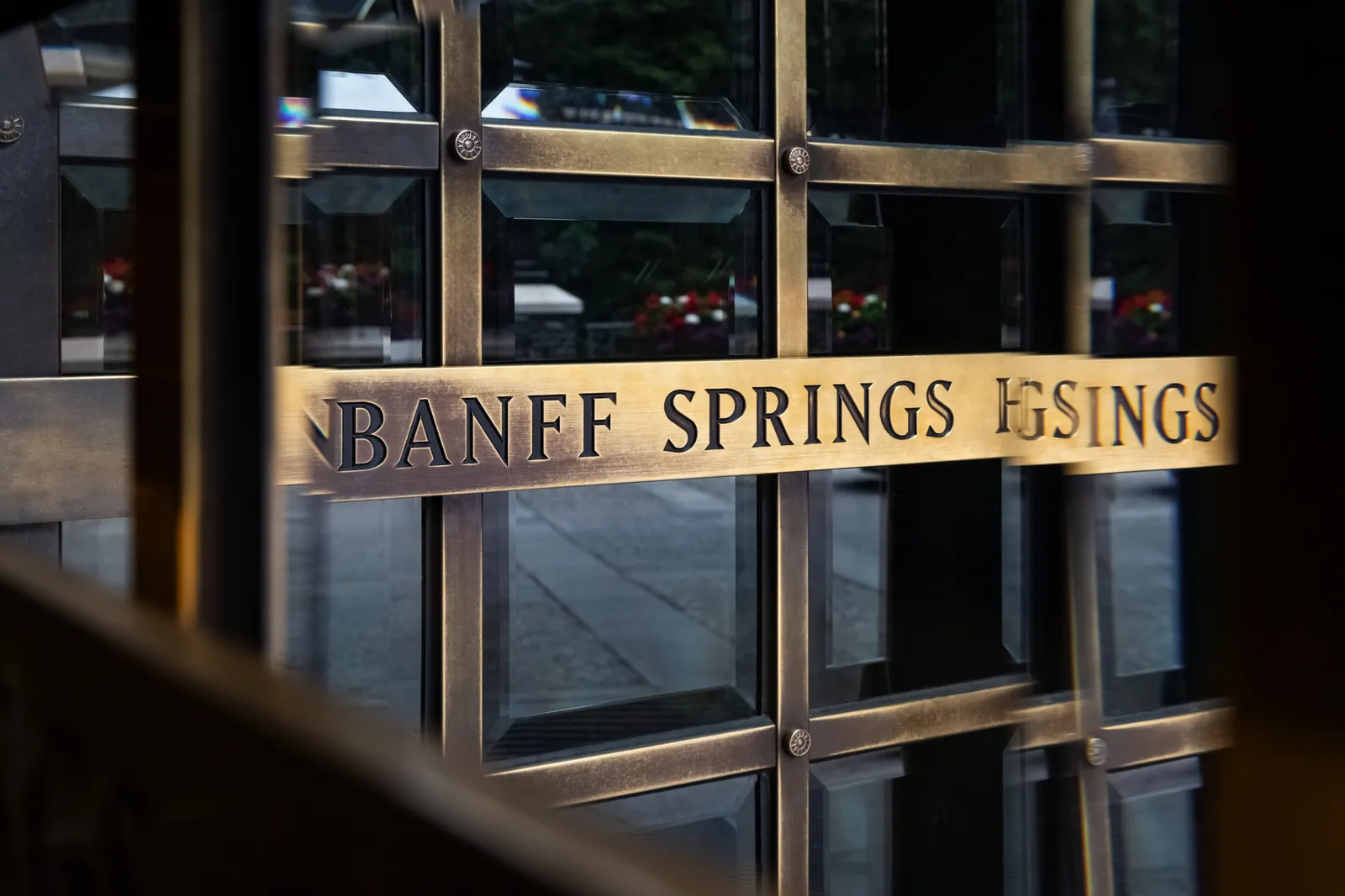 The glazed door at Fairmont Banff Springs, with the name on a brass plate