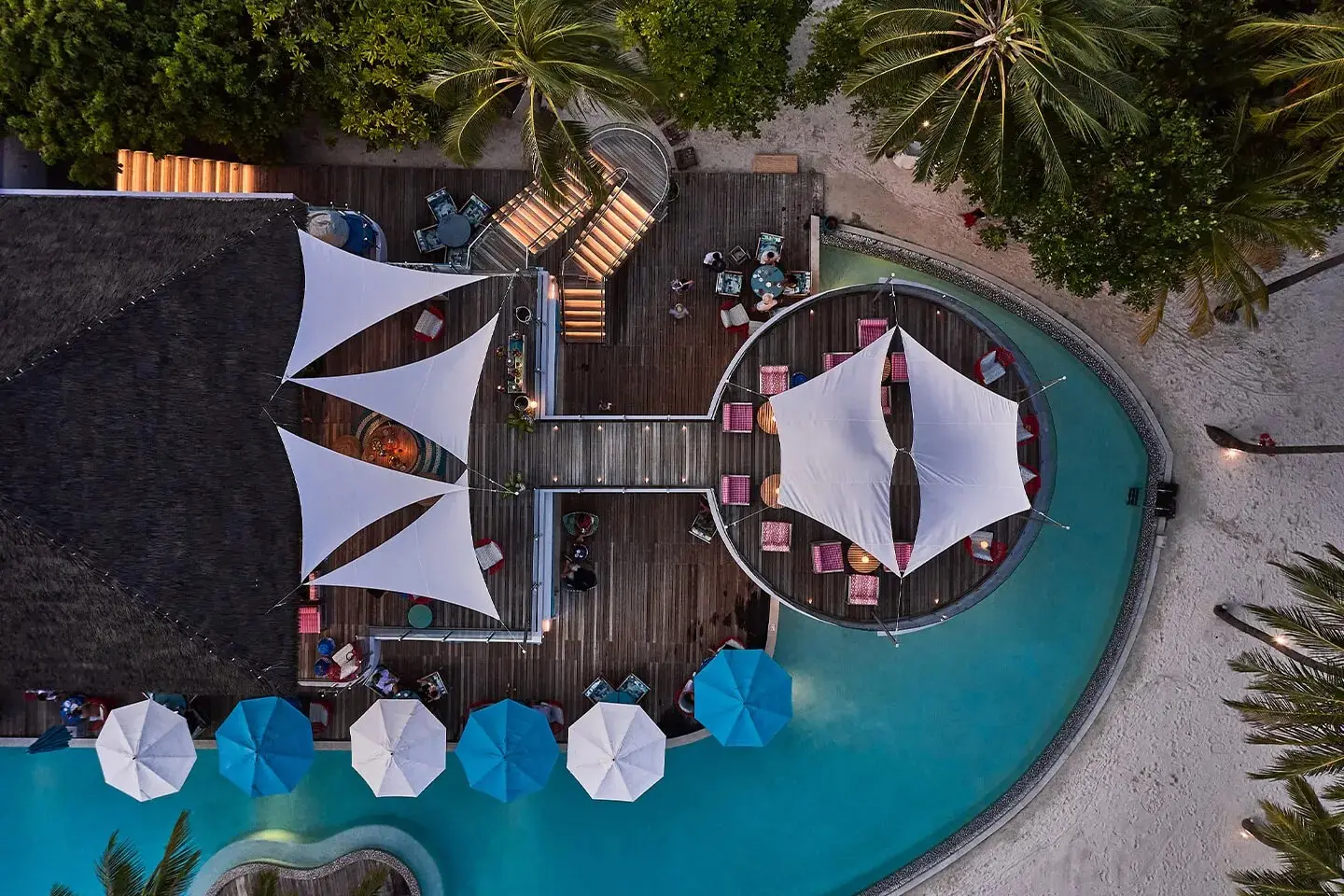 The Beach Club from above: white sails over the decks, the pool and the umbrellas