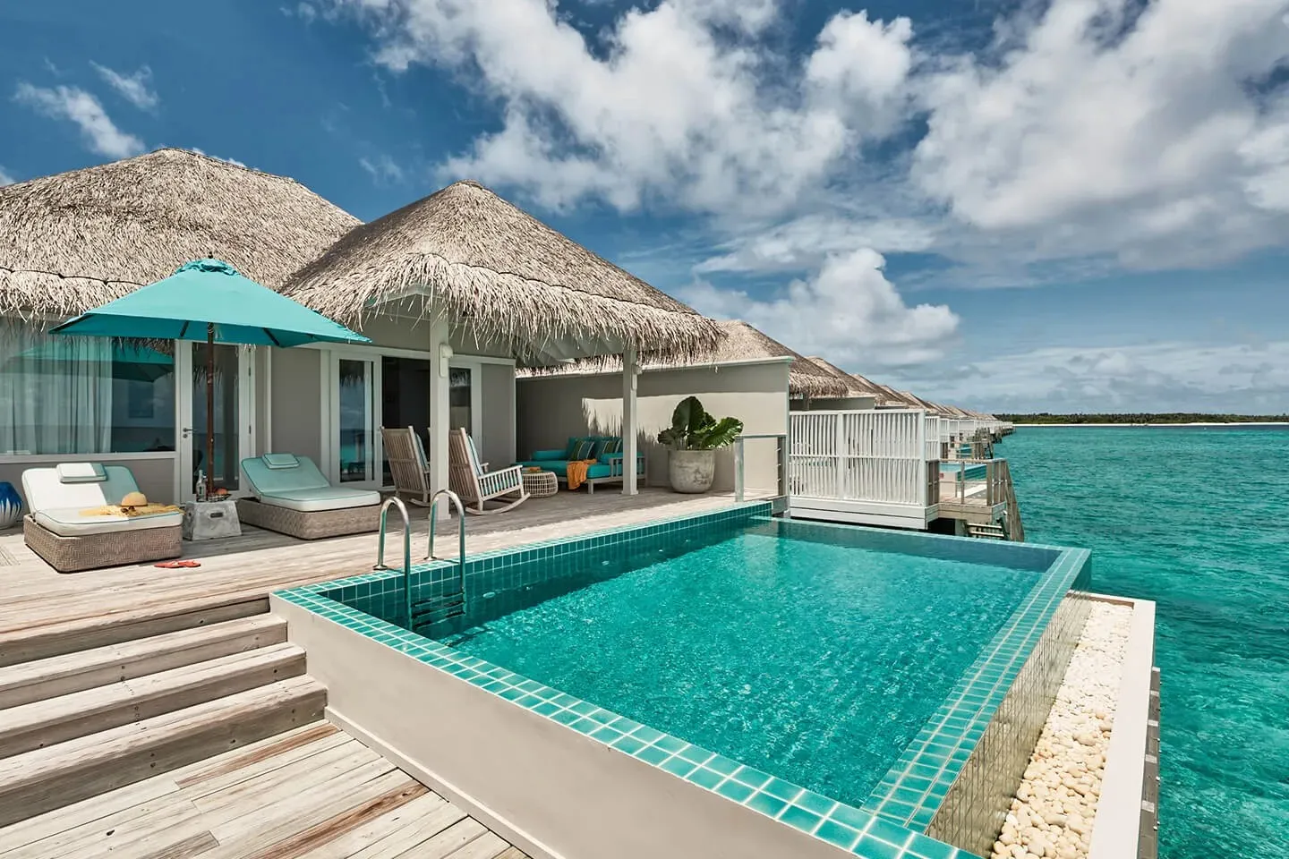 An Ocean Pool Villa’s pool on the deck, the turquoise lagoon alongside