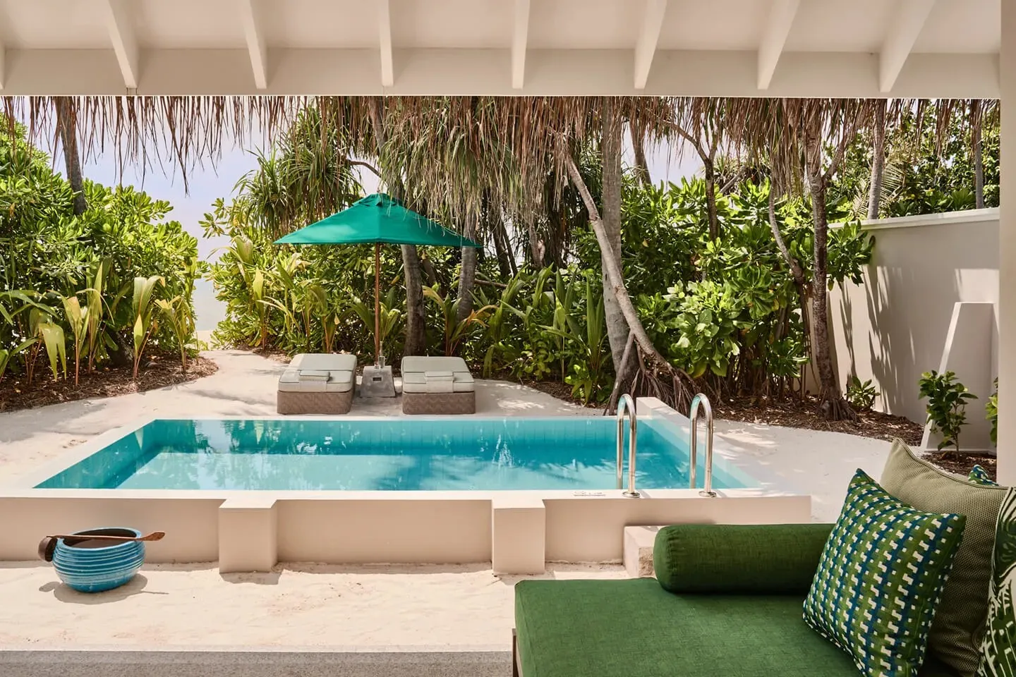 A Private Pool Villa’s pool, the green sofa and the tropical garden