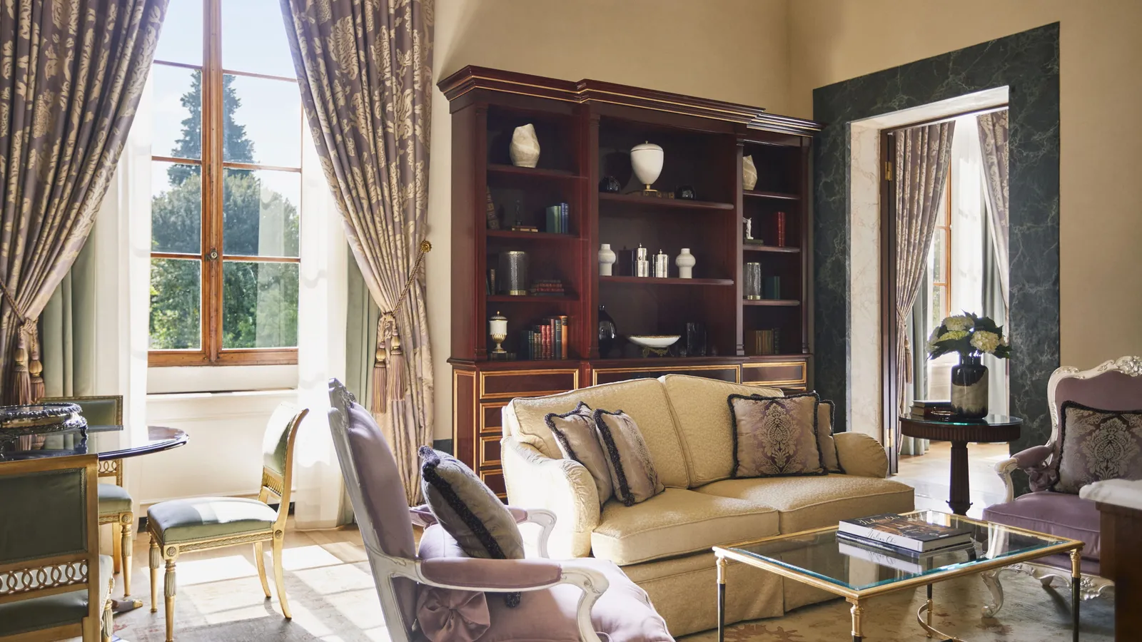 Frescoed Executive Suite living room with sofa, 2 arm chairs, and table with chairs, at Four Seasons Hotel Florence