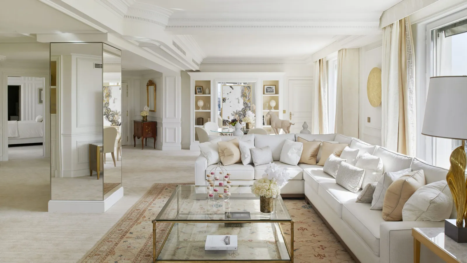 A pale sitting room with sofas and large windows
