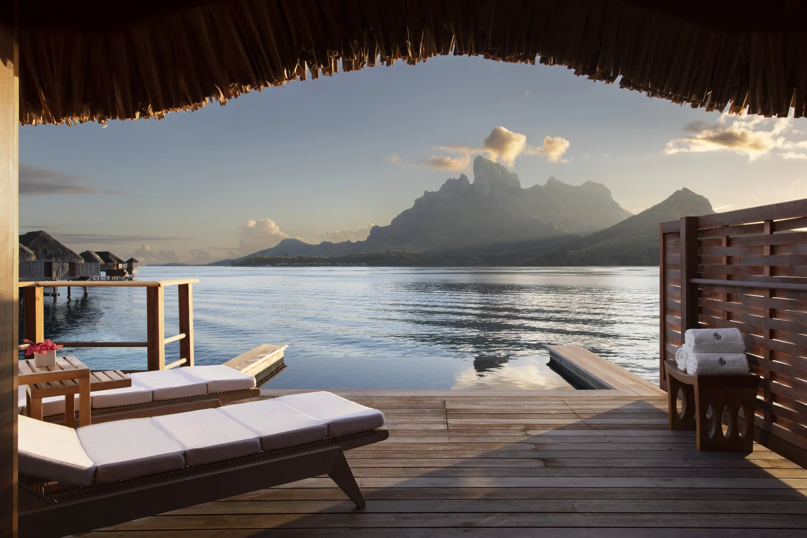 The deck with its loungers and plunge pool, Otemanu at dusk