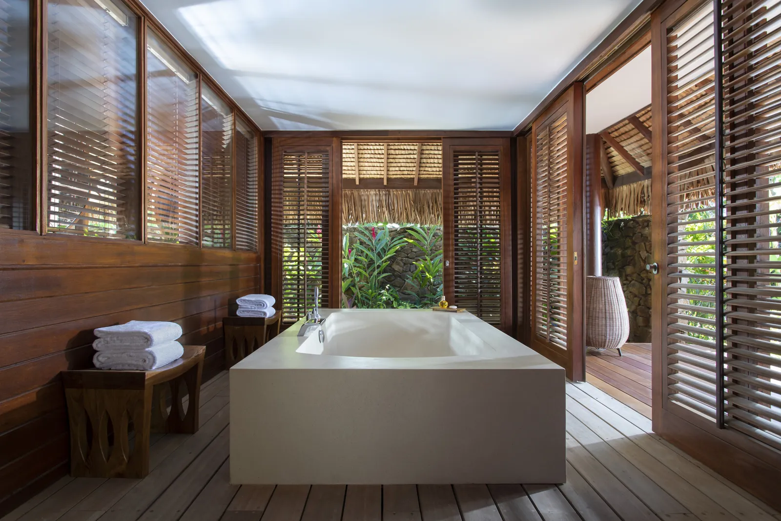 The bathroom pavilion, its tub and shutters open to the garden
