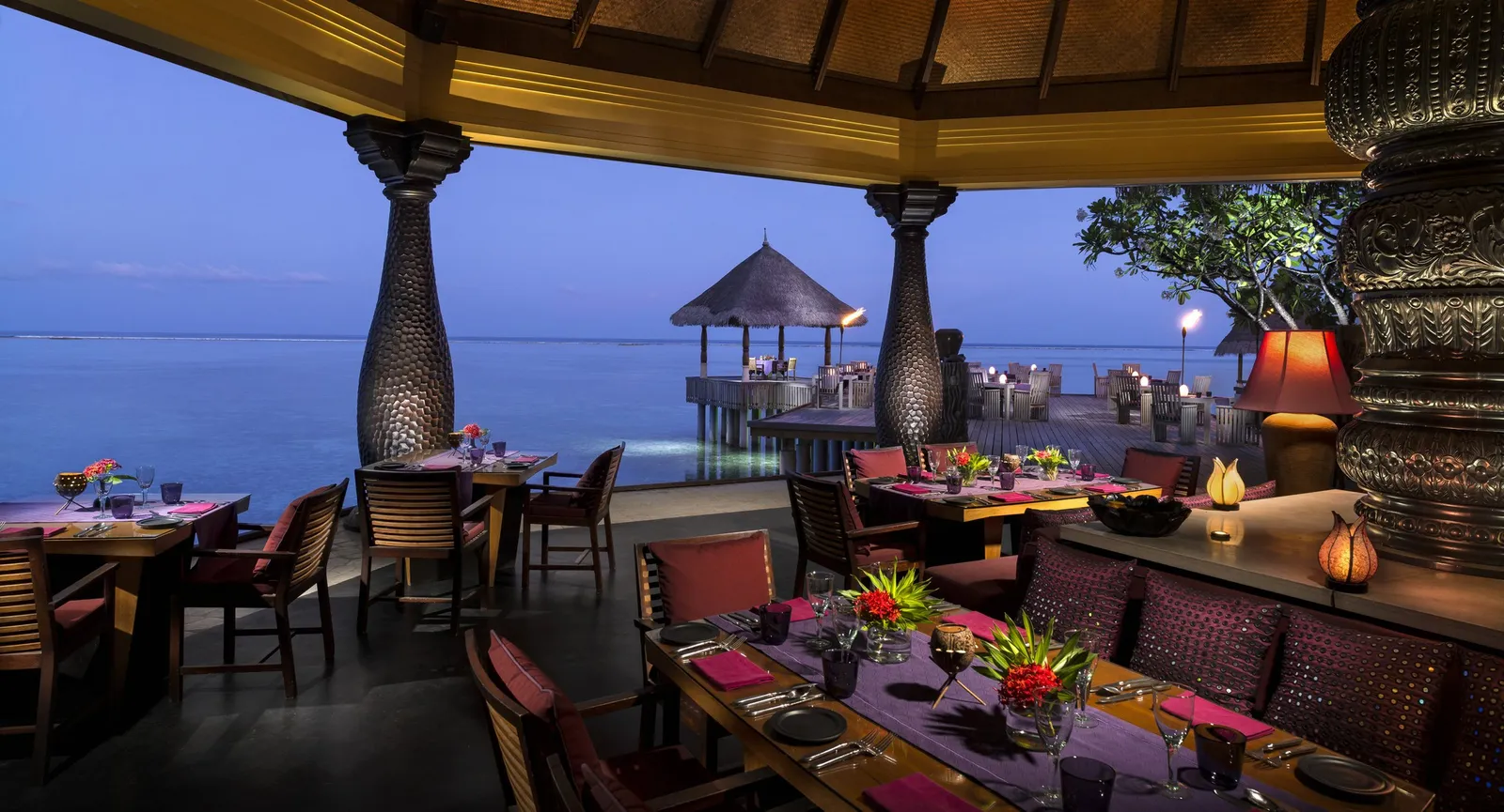 Baraabaru at night, tables laid over the lagoon and lanterns