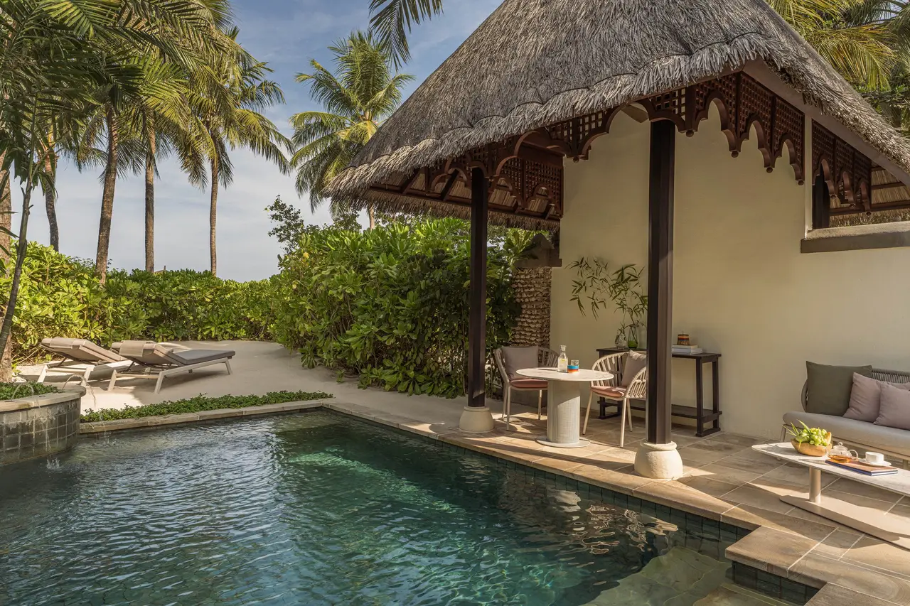 A Deluxe Beach Pavilion’s pool in front of the pavilion and the beach