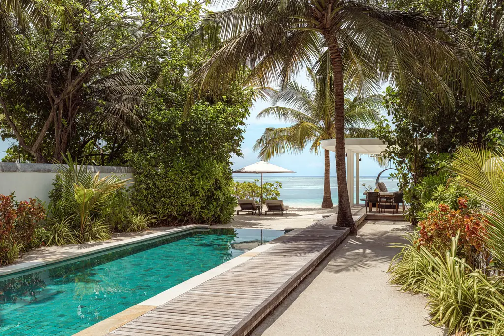 A Sunrise Beach Villa’s pool with its boardwalk to the beach